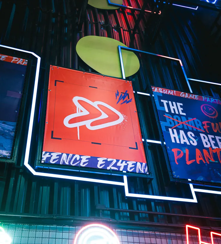 Parede com painéis e letreiros neon da Login